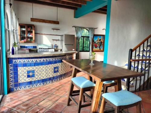 a kitchen with a wooden table and chairs in a room at Casa Pajaros - Skyview in Cruz de Huanacaxtle