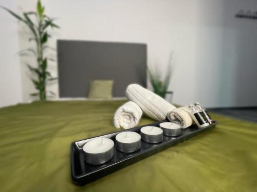a black tray with spa products on a bed at O5 residence in Nivy