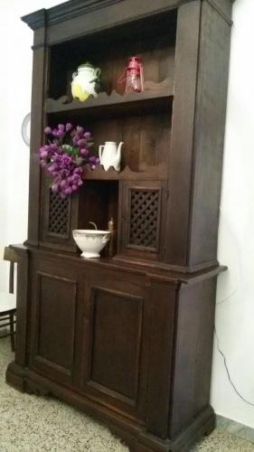 a wooden hutch with a bowl and flowers in it at alloggio turistico La Stalla in Tuscania