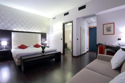 a hotel room with a bed and a couch at Hotel La Torretta in Bollate