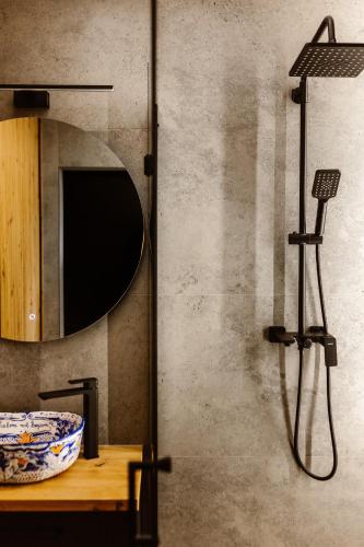 a bathroom with a mirror and a bowl on a table at Lizbona nad Bugiem in Gulczewo