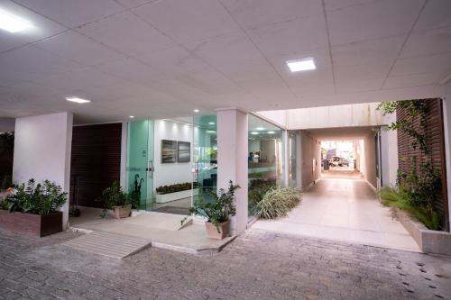 a lobby of an office building with potted plants at Hotel Conceição in Linhares