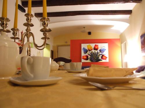 a table with white cups and saucers on it at Bed and Breakfast Adelberga in Salerno