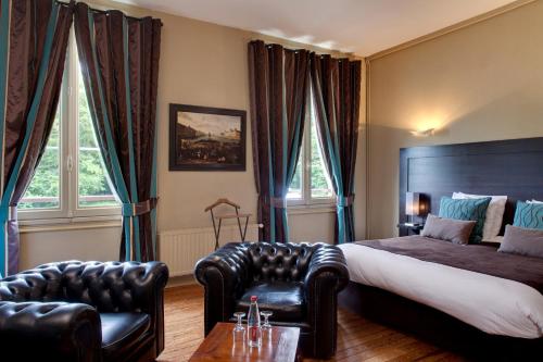a hotel room with a bed and a couch and chairs at Le Pavillon De Gouffern in Silly-en-Gouffern