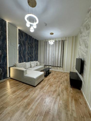 a living room with a couch and a television at City Tower 2BHK newly renovated 10 feb 2025 in Ajman 