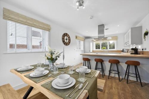 a kitchen and dining room with a table and chairs at Beautiful 4-Bed Detached House - Pool table - Superfast Wi-Fi - Driveway for two vehicles in Gloucester