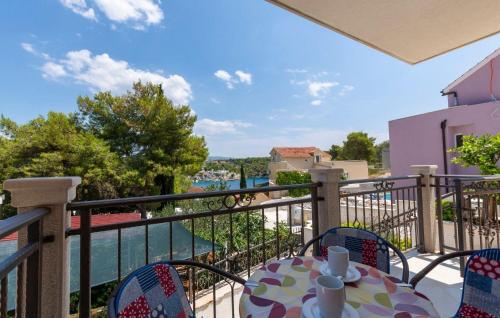 a balcony with a table and chairs and a view of the water at Apartments Dalis in Milna