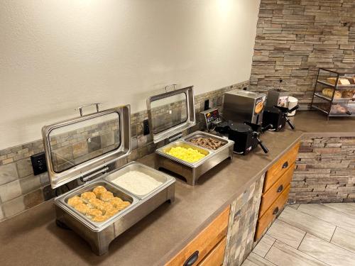 a bakery with three trays of food on a counter at Van Buren Hotel in Shipshewana