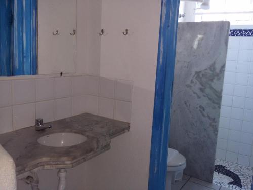 a bathroom with a sink and a toilet at Pousada Varanda do Sol in Arraial d'Ajuda