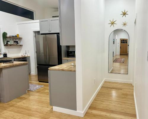 a kitchen with white cabinets and a large mirror at Sauger home in Saugerties