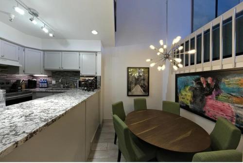 a kitchen with a wooden table and green chairs at Park City Ski in Ski Out in Old Town Walk To Main St in Park City