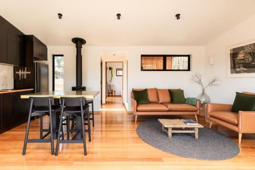 a kitchen and living room with a couch and a table at Arden Retreat - The Croft at Richmond in Richmond