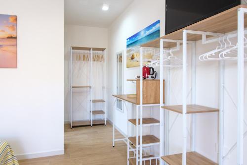 a room with white shelving and shelves in a room at Eos affittacamere in Castelsardo