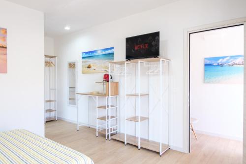 a room with white walls and a bed and a window at Eos affittacamere in Castelsardo