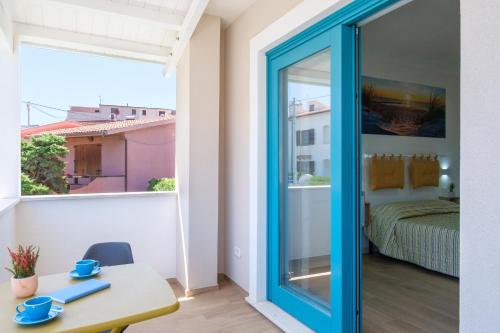 a room with a table and a view of a bedroom at Eos affittacamere in Castelsardo