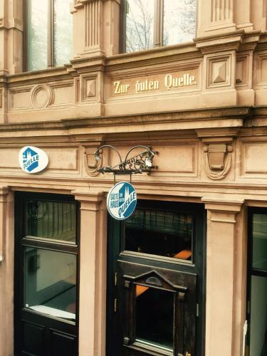 a building with a sign on the side of it at Zur guten Quelle in Cologne