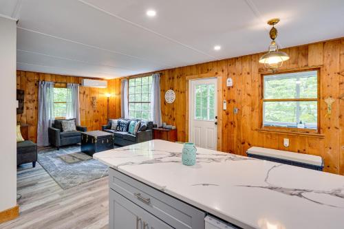 a kitchen and living room with wood paneling at Monterey Haven Less Than half Mi to Lake Garfield with Kayaks in Monterey