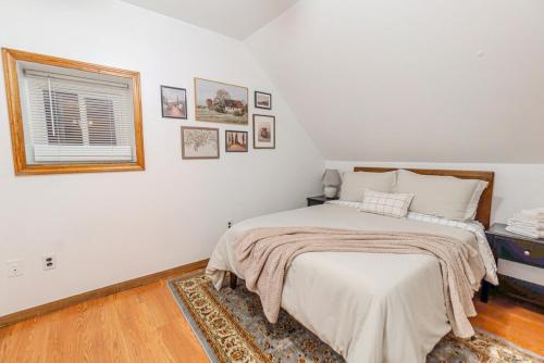 a white bedroom with a bed and a window at 4BDR Near Tufts-10min-Walk to Subway-Free Parking in Somerville