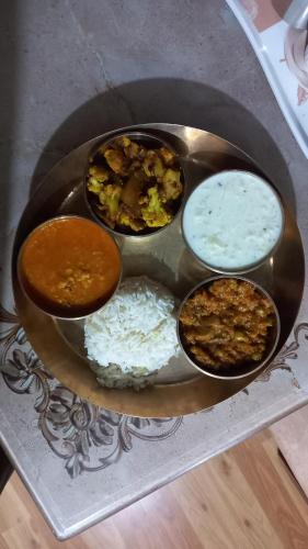 a plate of food with different types of food at Humble Holiday Home Kufri S H I M L A with Lawn and Amazing View in Kūfrī