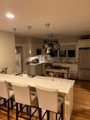 a kitchen with a table with chairs and a counter top at Jersey St Lovely in Marblehead