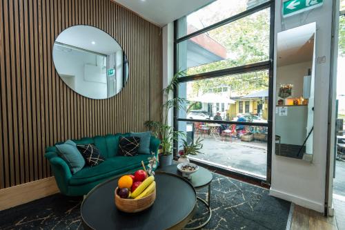 a living room with a couch and a table with fruit on it at Urban Nomad Potts Point - 18 to 39 only in Sydney