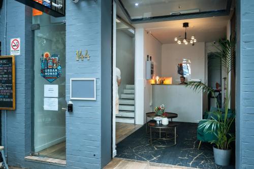 a door to a store with a table in front of it at Urban Nomad Potts Point - 18 to 39 only in Sydney