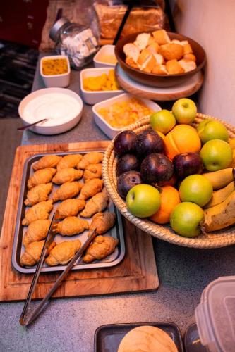 a table topped with baskets of fruit and other foods at Urban Nomad Potts Point - 18 to 39 only in Sydney
