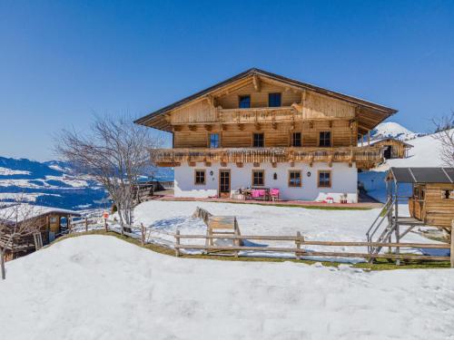a log cabin in the snow with a fence at Igl Hof Top 2 in Westendorf
