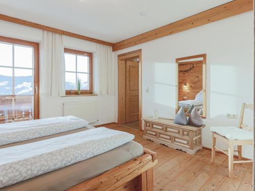 a bedroom with two beds and a mirror at Igl Hof Top 2 in Westendorf