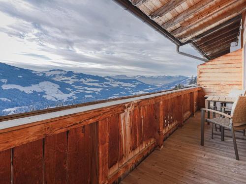 a balcony with a table and chairs and mountains at Igl Hof Top 2 in Westendorf