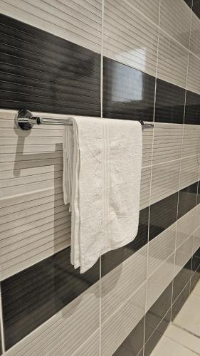 a towel hanging on a towel rack in a bathroom at Luxury Apartment A15 in Yanbu