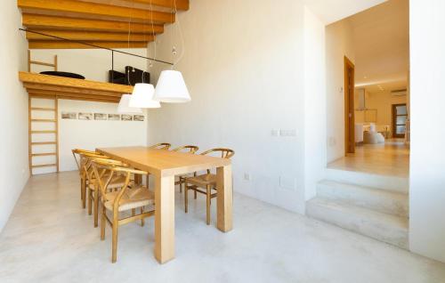 a dining room with a wooden table and chairs at Cas Jurat De Selva in Selva