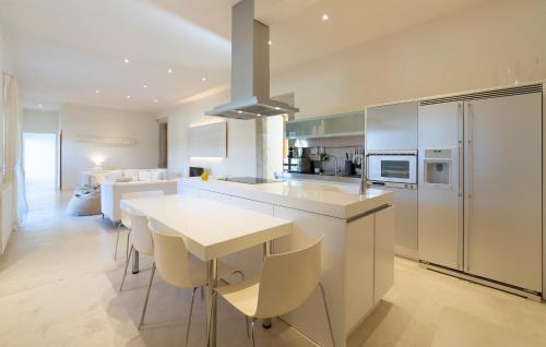 a kitchen with a white counter top and a table at Cas Jurat De Selva in Selva
