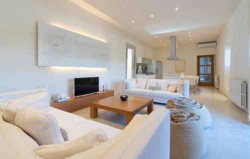 a living room with two white couches and a table at Cas Jurat De Selva in Selva