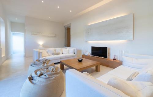 a living room with two white couches and a tv at Cas Jurat De Selva in Selva