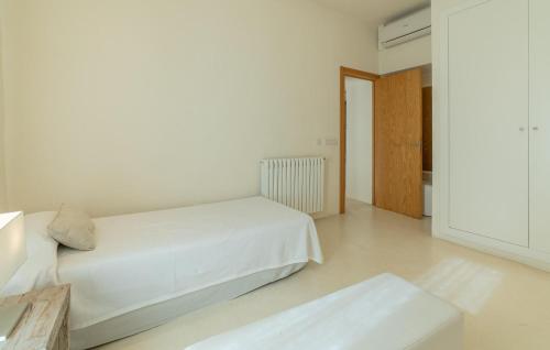 a white bedroom with a bed and a table at Cas Jurat De Selva in Selva