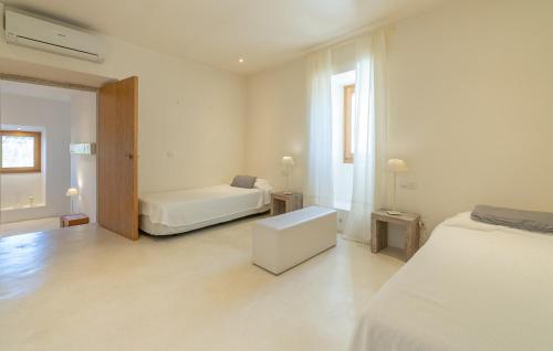a white bedroom with a bed and a couch at Cas Jurat De Selva in Selva