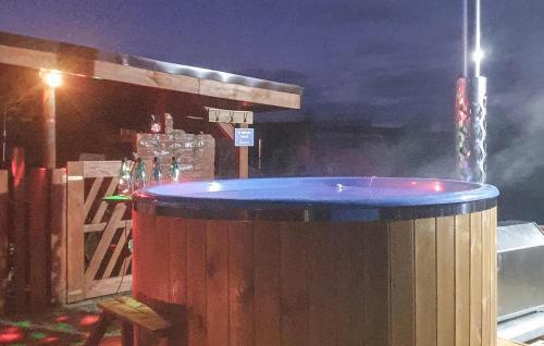 a bar with a large wooden barrel with a blue top at Lovely Home In Mielno Pyrzyckie in Mielno Pyrzyckie