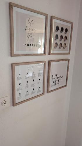three framed pictures on a wall in a room at Casa14 - Swiss houses in Steffisburg