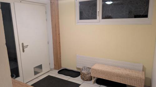 a room with a door and a bench and a window at Casa14 - Swiss houses in Steffisburg