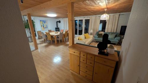 a living room with a couch and a dining room at Casa14 - Swiss houses in Steffisburg