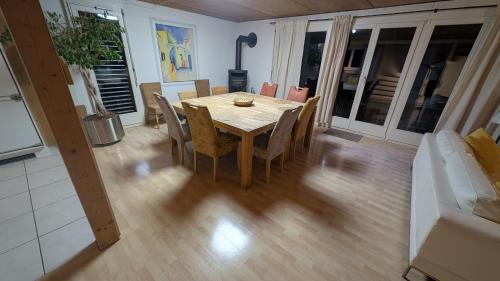 a dining table and chairs in a living room at Casa14 - Swiss houses in Steffisburg
