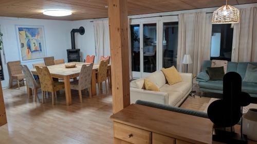 a living room and dining room with a couch and a table at Casa14 - Swiss houses in Steffisburg