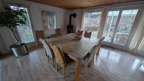 a dining room with a wooden table and chairs at Casa14 - Swiss houses in Steffisburg