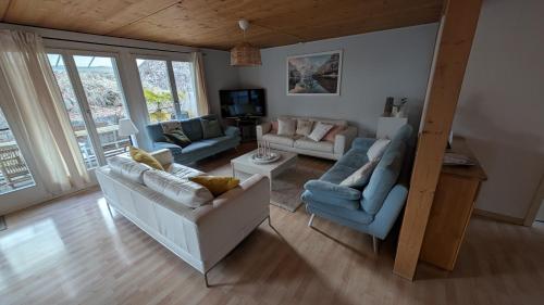 a living room with two couches and a tv at Casa14 - Swiss houses in Steffisburg