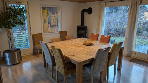 a dining room with a wooden table and chairs at Casa14 - Swiss houses in Steffisburg