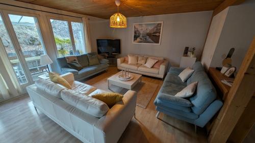 a living room with two couches and a tv at Casa14 - Swiss houses in Steffisburg