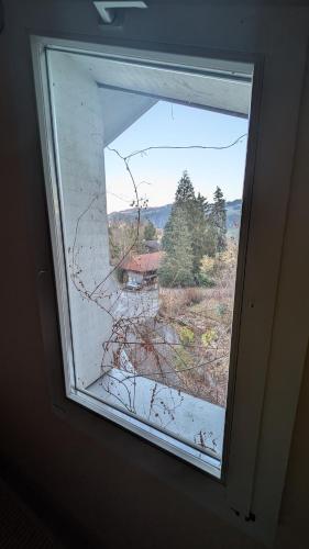 a window in a room with a view of a house at Casa14 - Swiss houses in Steffisburg