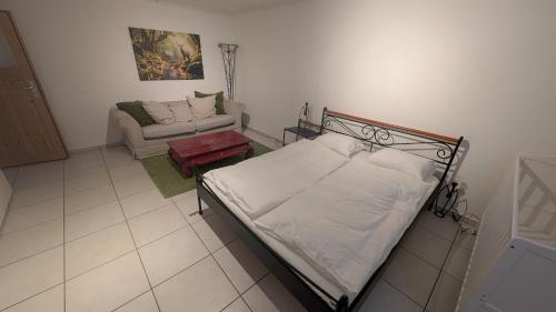 a bedroom with a bed and a couch at Casa14 - Swiss houses in Steffisburg