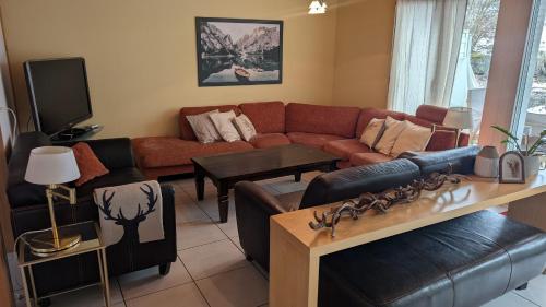 a living room with a couch and a table at Casa14 - Swiss houses in Steffisburg